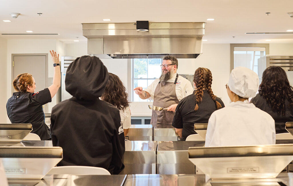 Culinary students in a teaching kitchen at Savannah Culinary Institute